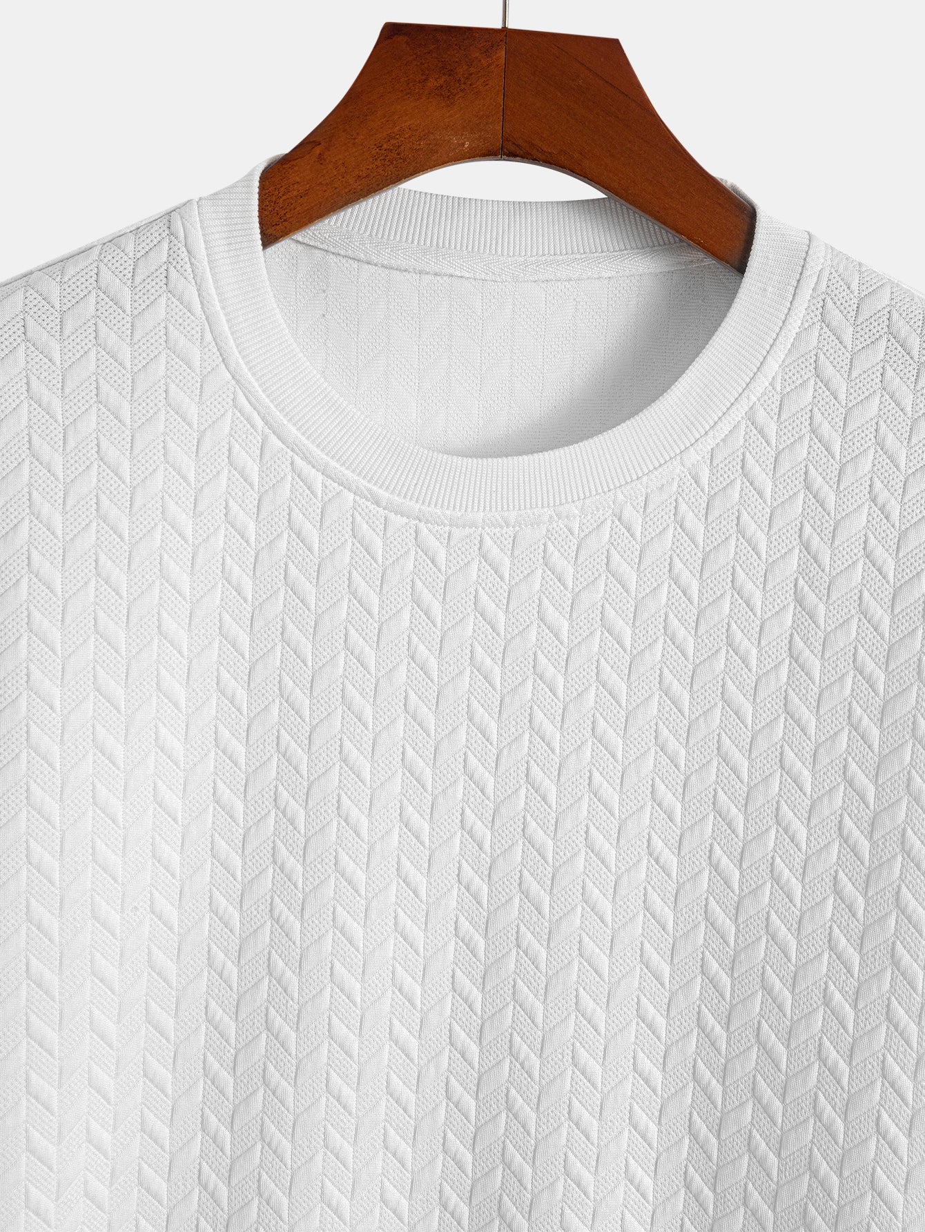 T-shirt con orlo ad arco e trama jacquard